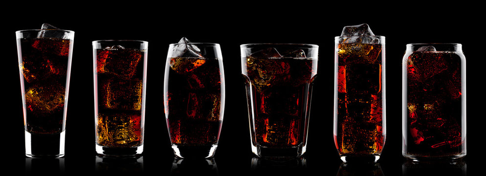 Cola soda drink glasses with ice cubes on black