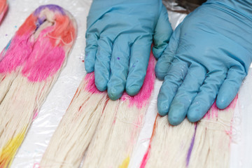 Hands in gloves in yarn dyeing process