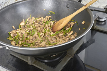 Happy woman cooking vegan food in the kitchen.
