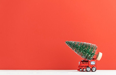 toy steam locomotive carries a Christmas tree