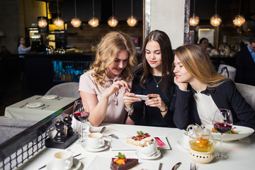 woman photographing food by smartphone