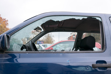 Broken side window glass on the damaged car door 