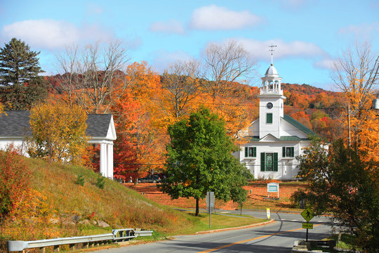 Small church in typical New England town with fall foliage