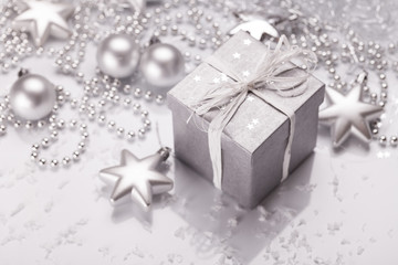 Christmas presents with silver ribbon on white wooden background