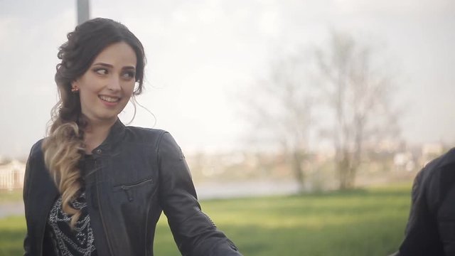 Young beautiful couple in leather jackets walking on a date