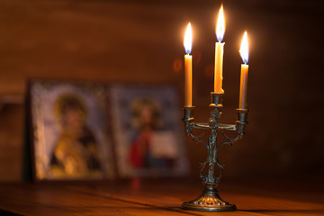 burning candle in a dark room, orthodox