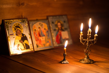 burning candle in a dark room, orthodox - obrazy, fototapety, plakaty