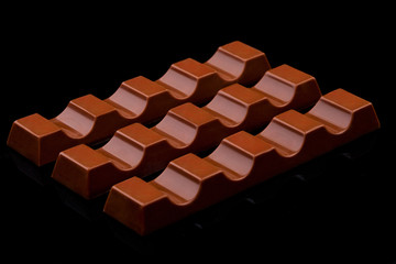 Milk chocolate sweet bars on black