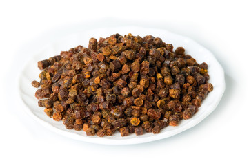 Propolis granules inside plate, bee product