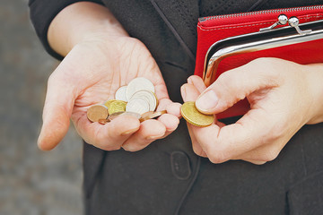 Coins in female hands, selective focus.