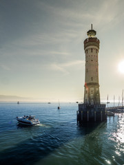 Motor boat departing at Lindau harbour, lake constance
