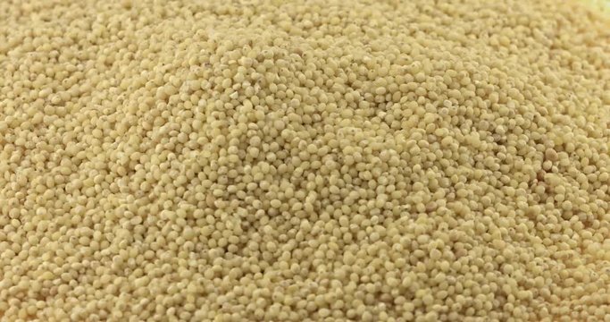 Close up of dry spilled millet rotating