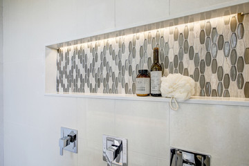 Stunning walk-in shower with white tile surround.
