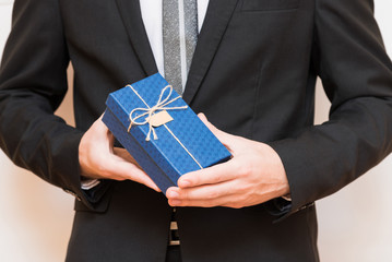 A man holding a gift box in his hands