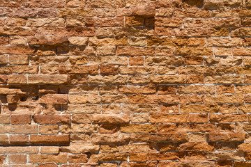 Wall, old and neglected, built of red baked bricks;  background; copy space; texture; pattern