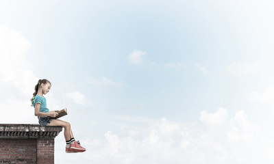 Concept of careless happy childhood with girl exploring this wor