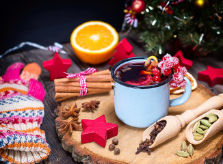 Mulled wine in an iron blue mug and drink ingredients