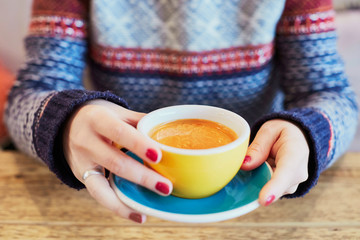 Woman hands with cup of hot coffee