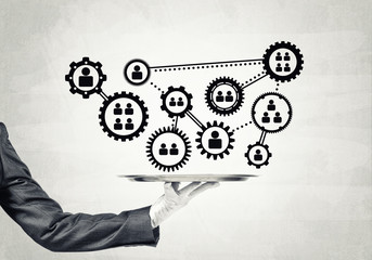 Waiter hand with white gloves holding silver plate full of social media communication icons