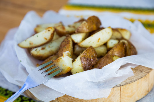 baked potatoes with spices on parchment