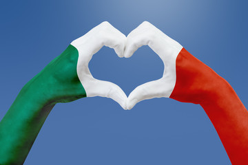 Hands flag of Mexico, shape a heart. Concept of country symbol, on blue sky.
