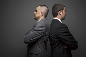 Two Businessman Posing On The Gray Wall