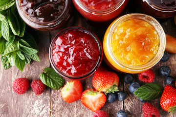 assortment of jams, seasonal berries, plums, mint and fruits - obrazy, fototapety, plakaty