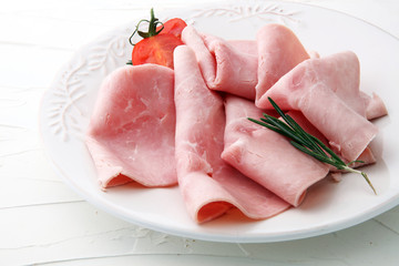 Sliced ham on white background. Fresh prosciutto. Pork ham sliced.