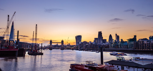 Fototapeta premium London skyline at colourful sunset including Tower Bridge and skyscrapers at financial district