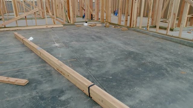 Cement floor and wood walls of new home construction