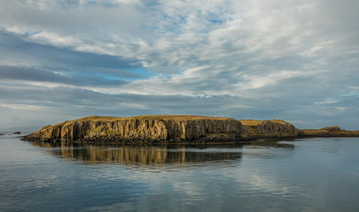 Volcanic Island in Western Iceland under Cloudy Blue Sky