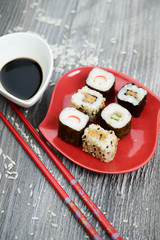 Sushi and soy sauce on the rustic table 