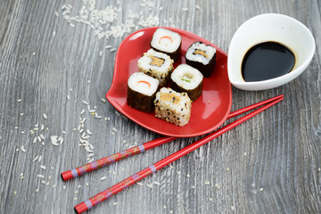 Sushi and soy sauce on the rustic table 