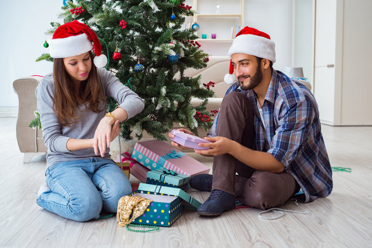 Young Woman Receiving Gold Watch As Christmas Gift