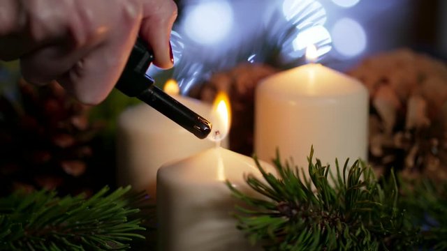 4K Beautiful Long CloseUp of Lighted White Candles with F Christmas Ornament as Decor on Eve in Slow Motion