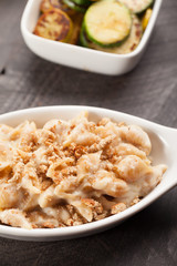 Freshly made pasta with creamy sauce and breadcrumbs on top with side of roasted veggies
