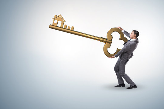 Businessman holding key in real estate concept - Powered by Adobe