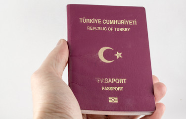 Hand holding Turkish passport