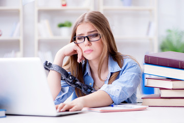 Young teenage female student preparing for exams at home