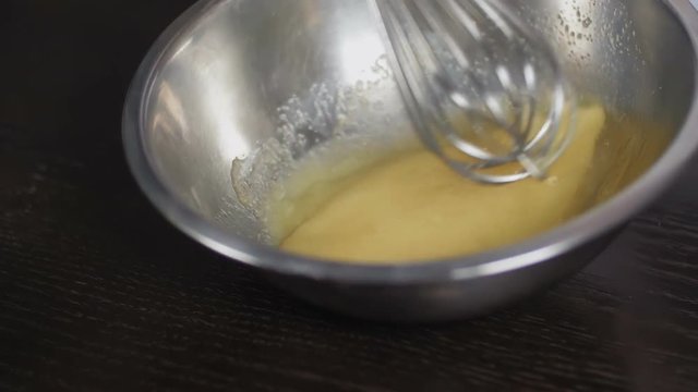 Whisking yellow batter and eggs