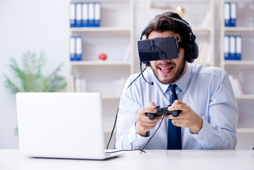 Businessman gamer in office playing games