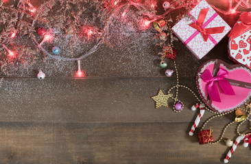 Christmas background, light and gift box  on old wood