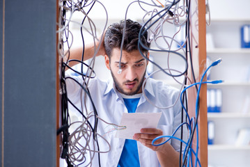 Computer repairman working on repairing network in IT workshop