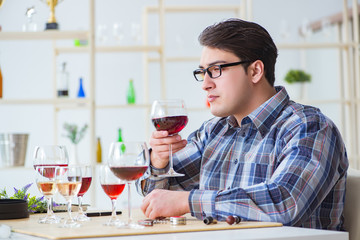 Professional sommelier tasting red wine 