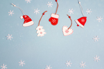 Winter holiday background with red decorations on blue. Space for text.