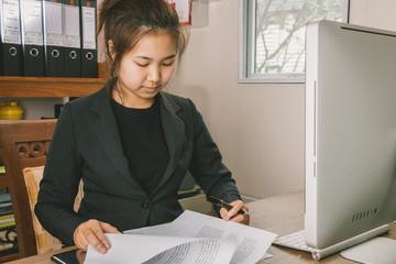 Businesswoman checking terms and conditions at her desk in the office, business busy concept