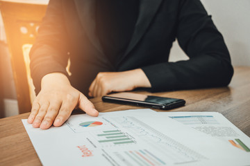 Asia businesswoman presenting graph analysis documents paper