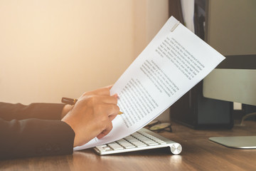 Business woman reading document paper on working table