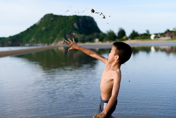 Boy play with a sand on the beach