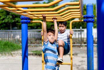 Fototapeta na wymiar Young asian boy hang out door playground